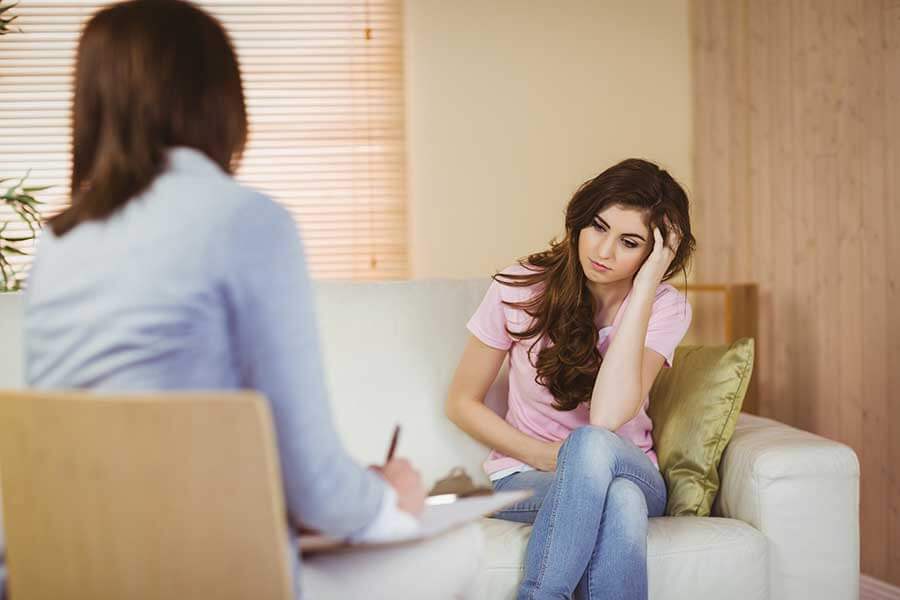 A psychotherapist helping an addiction patient.