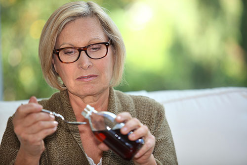 Older woman taking cough syrup may be headed for codeine addiction treatment.